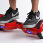 Red_self-balancing_two-wheeled_board_with_a_person_standing_on_it